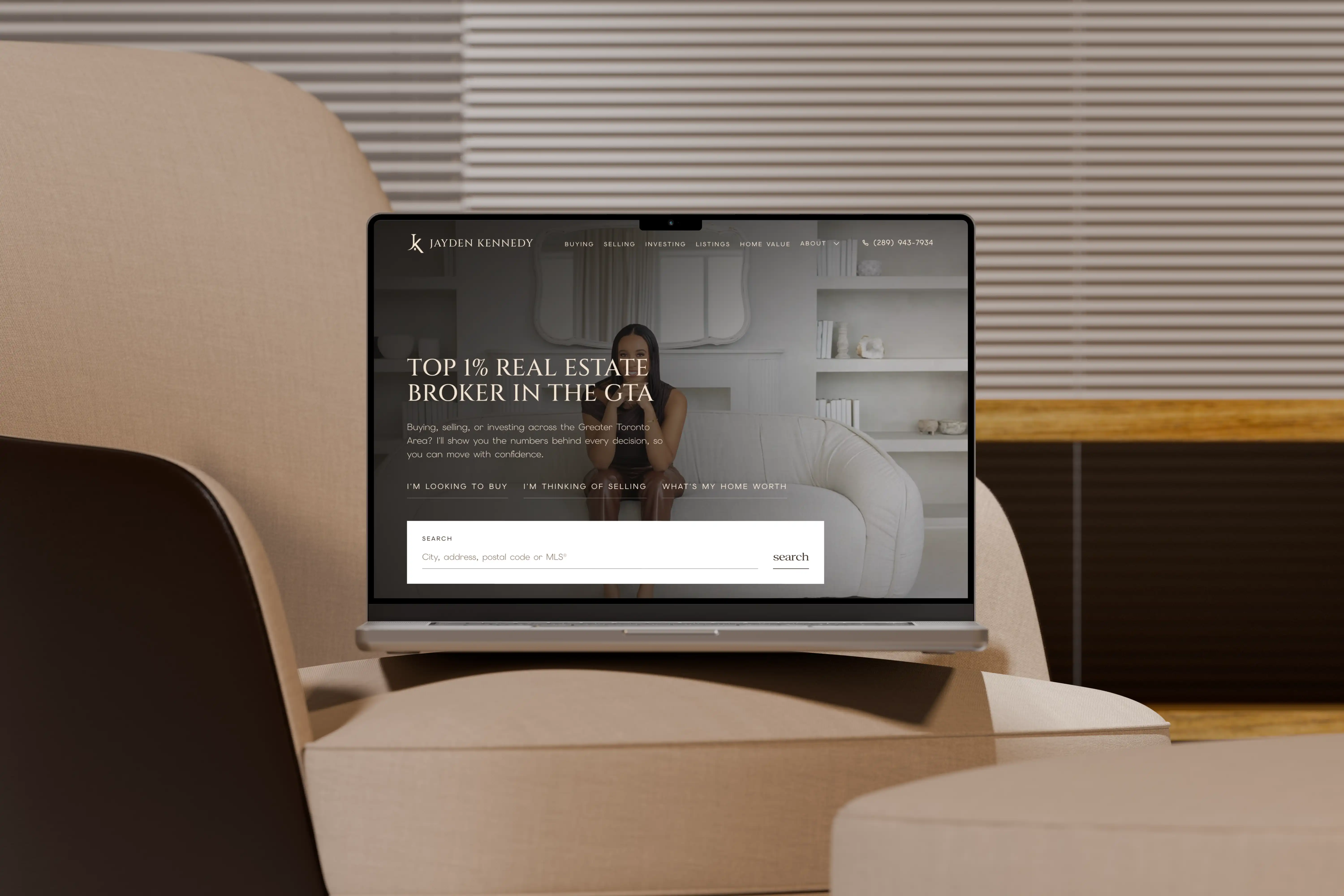 Jayden Kennedy real estate website shown on a laptop